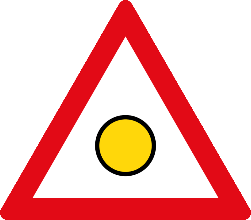 "Danger" flashing light sign. A flashing danger light is operating ahead — slow down and be prepared to stop.